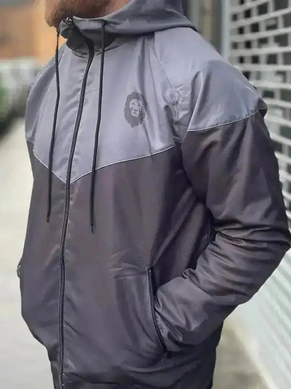 Two-tone gray zip-up hooded jacket with lion logo and side pocket