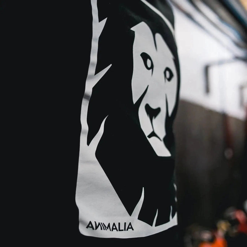 Black organic cotton t-shirt with white lion head graphic and Animalia logo