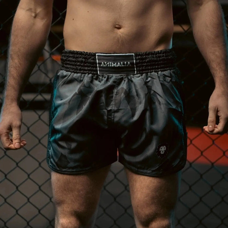 Front view of unisex Camo Muay Thai shorts with elastic waistband label