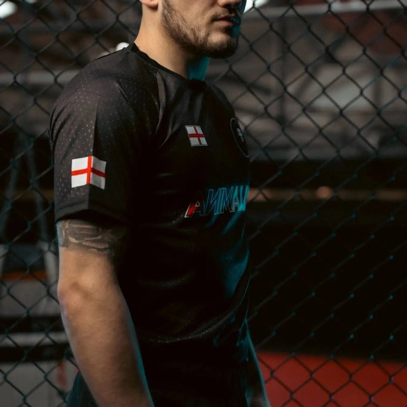Side view of black England combat sports shirt with sleeve flag