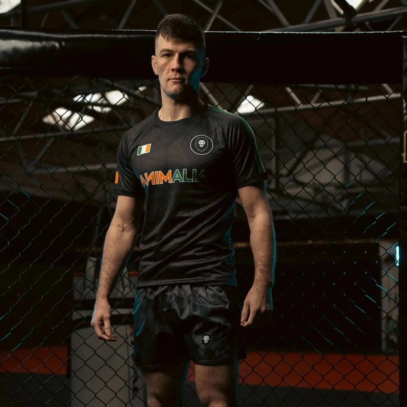 Men's black athletic t-shirt front fit showing Irish flag patch, lion logo, and Animalia branding