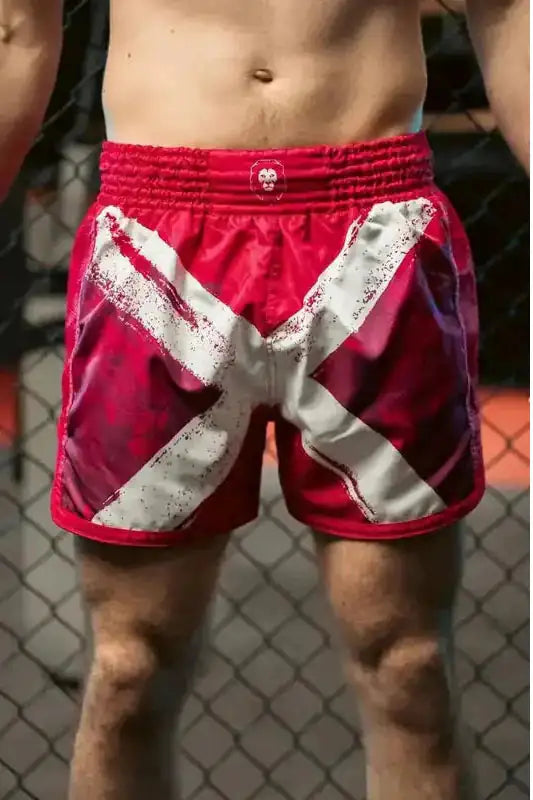 pink Muay Thai shorts with white saltire graphic and satin finish