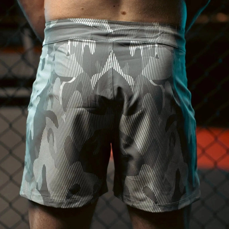 Back view of gray white black striped camo MMA shorts with elastic waistband