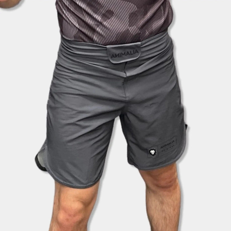 Dark gray Animalia MMA shorts front view with lion logo label and relaxed fit