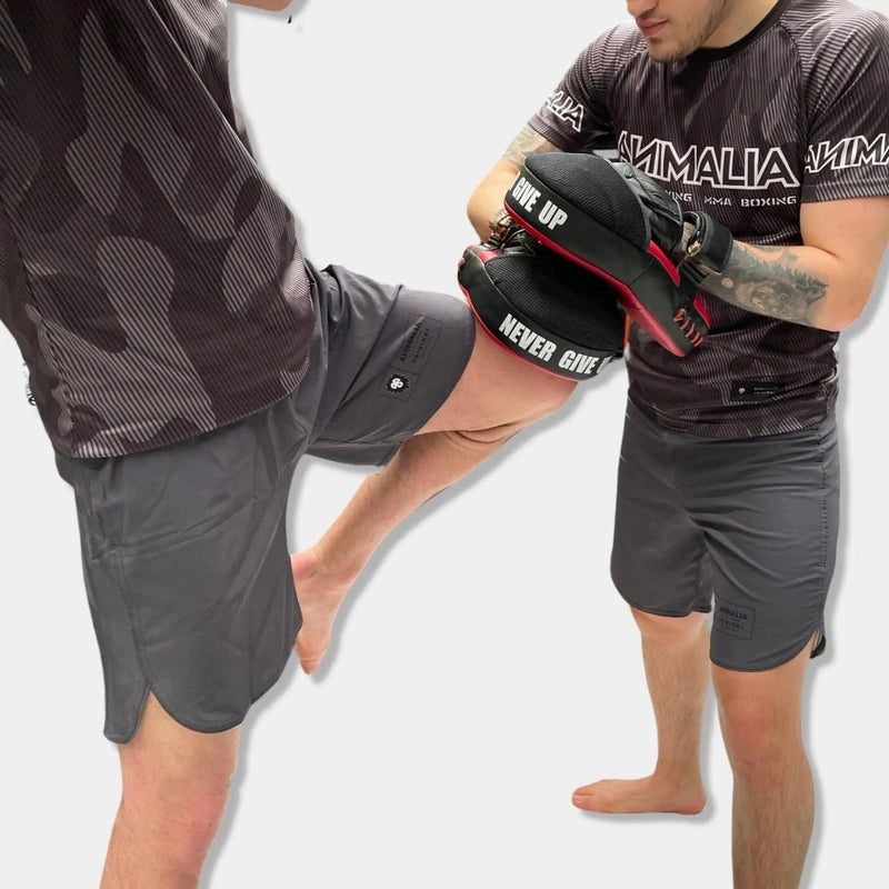 MMA lightweight dark gray athletic shorts in action kickboxing stance