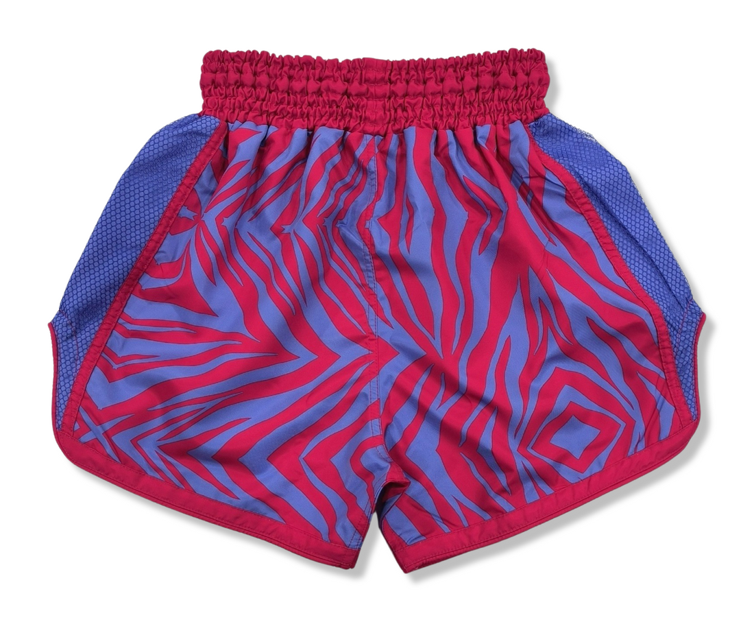 These Pink and Purple Zebra Print Muay Thai Shorts are perfect for any Muay Thai or kickboxing enthusiast looking to add some fun and bright colors to their gear.  With a trippy zebra print design, these shorts are sure to make a bold statement in the ring.