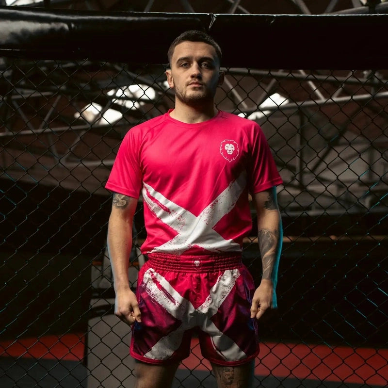Model wearing fuchsia pink Saltire athletic fit t-shirt in gym setting