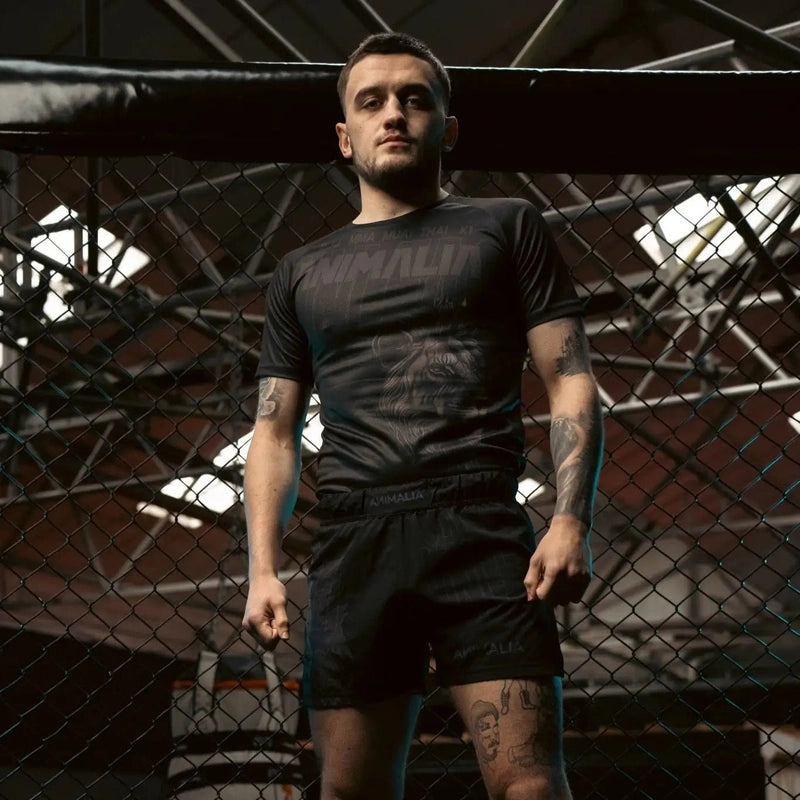 Fitted black performance T-shirt featuring lion design for martial arts training